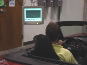 Photo: Driver watching computerized display showing  test schedule and driving statistics